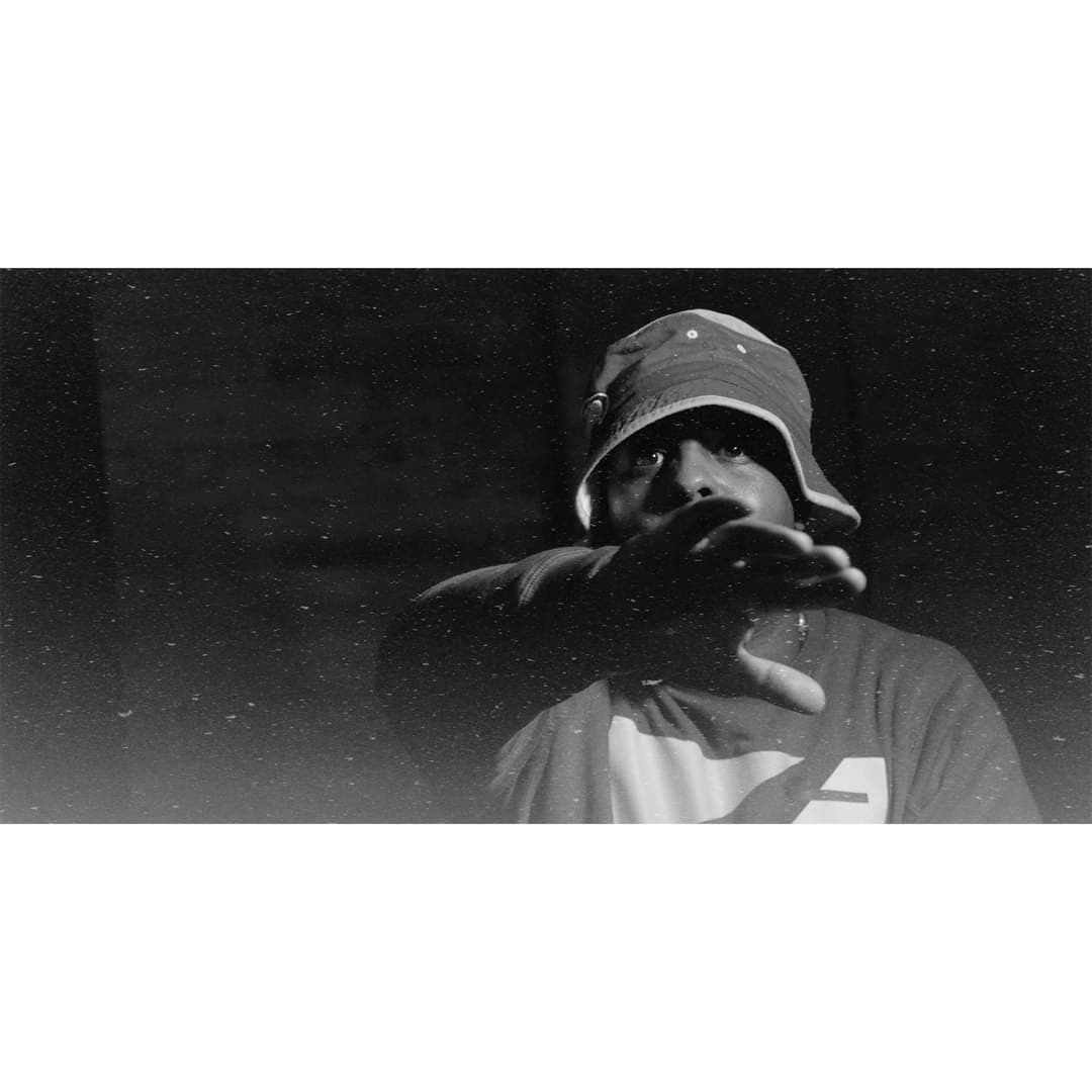 a black and white photo of a man in a hat